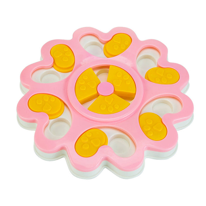 Pink and yellow toy with a central wheel on a white background