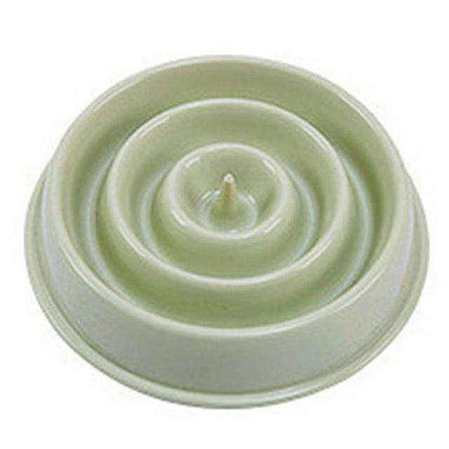 Green ceramic dish with concentric circular design on a white background